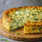 Golden baked cottage cheese & spinach crustless quiche in a pie dish, showing a fluffy, cheesy filling with spinach and veggies — a healthy twist on a classic quiche and one of the best savoury breakfast ideas.