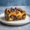 Golden, flaky chocolate croissant bake in a casserole dish dusted with powdered sugar—an easy Chocolate Breakfast Casserole that doubles as the Best Dessert For Brunch, perfect for Recipes For Brunch Party or Make And Take Breakfast Ideas.