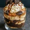Close-up of a layered trifle in a glass bowl showing brownie chunks, creamy cheesecake filling, and Oreo crumbs — a tempting Oreo Trifle Recipe with a playful Cookie Dough Trifle nod for Trifles Desserts lovers; also reads clearly as an Oreo Trifle visual.