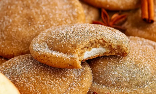 A batch of chewy Apple Cider Cheesecake Cookies filled with creamy cheesecake, brushed with butter, and dusted in spiced sugar — the ultimate Fall Festive Food and one of the Best Fall Cookie Recipes for cozy baking.