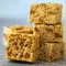 Stack of gooey Rice Krispie Treats made with cookie butter, crushed Biscoff cookies, and marshmallows — the ultimate Krispie Treats Recipe and one of the easiest Biscoff Recipes for chewy Cereal Treats and quick Easy Summer Desserts.