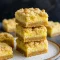Golden, crumbly Lemon Shortbread Bars with creamy filling on a platter, perfect Lemon Savory dessert for Baking For A Crowd. Delicious Lemon Bars With Shortbread Crust sliced into squares, each Lemon Bar bright and fresh for Easy Easter Desserts. Best Lemon Bars Recipe for buttery Shortbread Bars, a must-try Sweet Bar for lemon lovers.