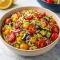 A bowl of colorful orzo pasta mixed with roasted zucchini, bell peppers, onions, and cherry tomatoes, garnished with fresh herbs and feta — the perfect Roast Vegetable Dinner and Healthy Vegetable Main Dish Recipes for a quick, vibrant weeknight meal.