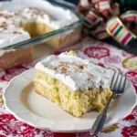 Close-up of a chilled slice of eggnog tres leches cake with whipped cream and a dusting of nutmeg — a dreamy Tres Leches Cake Recipe for Holiday Eggnog Desserts, as moist as a Moist Eggnog Bundt Cake, creamy like an Easy No Bake Eggnog Cheesecake, finished like an Eggnog Cake With Eggnog Frosting, the perfect Festive Eggnog Dessert twist on Cream Cheese Cake Recipes and Easy Cake Recipes, with a cheeky nod to eggnog Slushies.