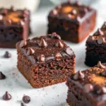 Fudgy Pumpkin Brownies topped with melted chocolate chips, a healthy fall treat that’s gluten-free, vegan, and packed with rich pumpkin flavor.