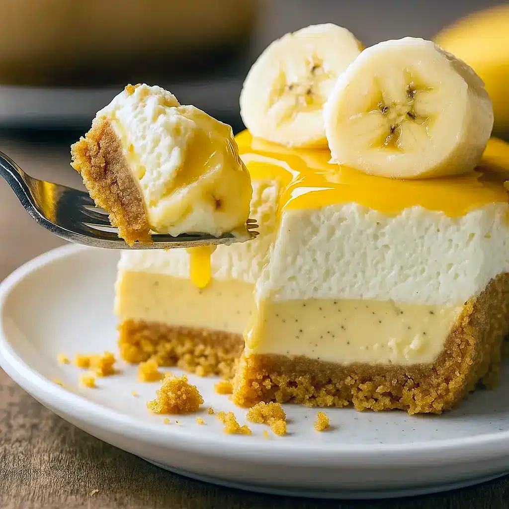 A creamy No Bake Banana Pudding Cheesecake topped with whipped cream, sliced bananas, and vanilla wafer crumbs, the perfect dessert for fans of Banana Pudding Cheesecake No Bake and classic Sweet Baking Recipes.