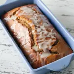 A moist Gingerbread Cake topped with glossy ginger icing, sliced and ready to serve — the Best Gingerbread Loaf Recipe for cozy mornings or a Cookie Exchange, inspired by a classic Gingerbread Coffee Cake Recipe Allrecipes style with hints of Spiced Gingerbread Loaf and Iced Gingerbread Loaf charm.