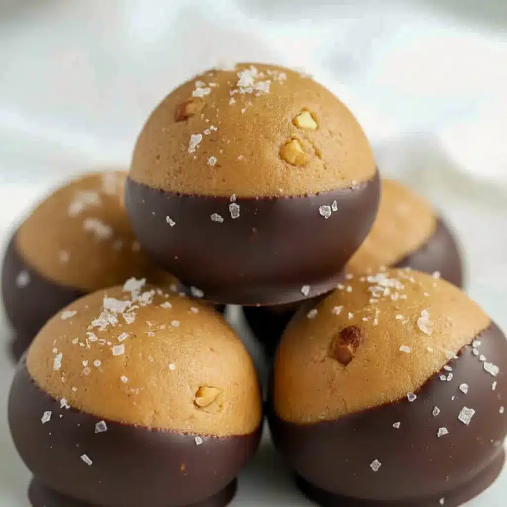 Close-up of chocolate-dipped Buckeyes Recipe balls made with creamy Healthy Peanut Butter, showing glossy chocolate coating and soft peanut butter center — the ultimate Healthy Chocolate Peanut Butter Treats for dessert or snack.