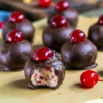Close-up of glossy Chocolate Cherry Bourbon Balls topped with candied cherries — the perfect Cherry Balls Christmas treat for festive dessert tables and Holiday Snack Gifts.