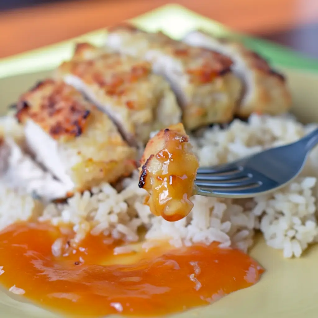 Golden crispy Coconut Chicken served with a glossy apricot mustard dipping sauce on a plate with rice, a delicious twist on Chicken Dinner Recipes, inspired by tropical Apricot Recipes and restaurant-style Chicken Main Dishes, perfect for Poultry Recipes lovers looking for simple Chicken Dishes Recipes, easy Main Meals, and fun alternatives to Turkey Recipes, similar to a homemade Pollo Loco meal.