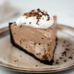 Dessert Parfait-style shot of a glossy chocolate pie slice topped with whipped cream and shavings, a tempting example of Keto Friendly Desserts and Low Carb Sweets, Low Carb Dessert.
