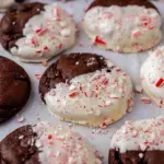 Close-up of a half-dipped cookie showing gooey chocolate chunks and a white-chocolate peppermint coating — a simple Peppermint Bark Cookies Recipe for holiday trays, one of the best Christmas Dessert Ideas Chocolate, styled as elegant Half Dipped Cookies and a top Chocolate Peppermint Recipes riff with Christmas Crumbl Cookie vibes, Chocolate Peppermint Bark Cookies.