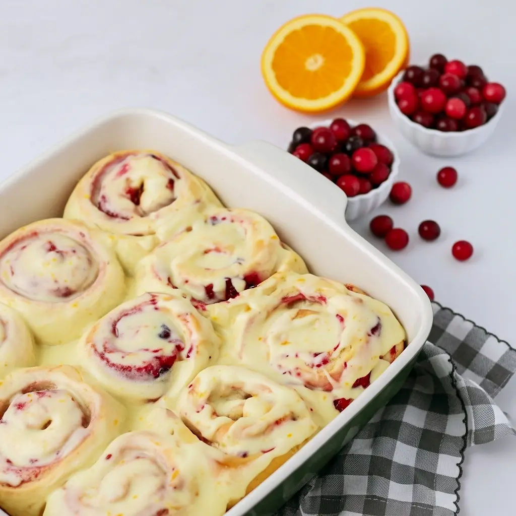 Glazed Orange Sweet Rolls on a platter — a cozy Holiday Baking scene ready for Thanksgiving Brunch; a bite shows jam, perfect Breakfast Sweets inspired by top Cranberry Recipes for Christmas Breakfast, a classic Sweet Roll for Breakfast Brunch Recipes or a Boulangerie display.