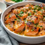 Close-up of a glazed Bang Bang Salmon fillet drizzled with spicy cream sauce, sprinkled with sesame seeds and green onions, served with rice — a hearty Fish Dinner, elegant Salmon Dishes, and a smart Recette Santé option, Salmon Recipes Baked Healthy.