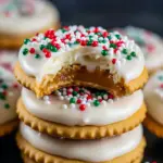Caramel-filled Ritz cracker sandwiches dipped in white chocolate and topped with red, white, and green sprinkles on a festive plate, Christmas Sweet Treats.