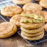 A stack of freshly baked snickerdoodle cookies dusted in cinnamon sugar, showing soft centers and crackled tops on a cooling rack, Soft And Chewy Snickerdoodle Cookies Recipe.