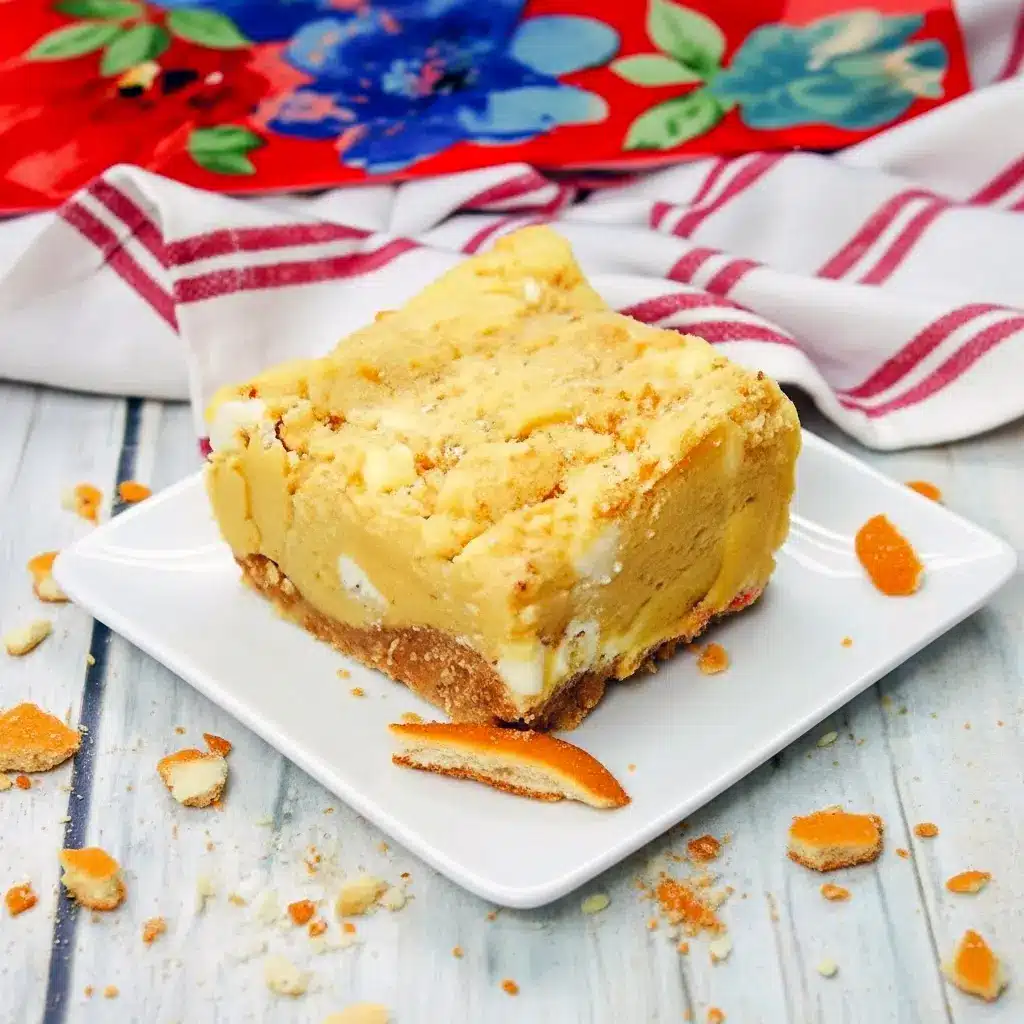 Close-up of a gooey Banana Blondies Recipe square on parchment, showing a golden vanilla-wafer crust, white chocolate pockets, and a fork ready to dig in.