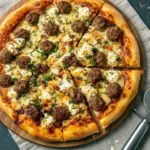 Homemade Pizza close-up: golden crust topped with crumbled sausage, ricotta dollops, melted mozzarella and a glossy hot-honey drizzle, garnished with basil.