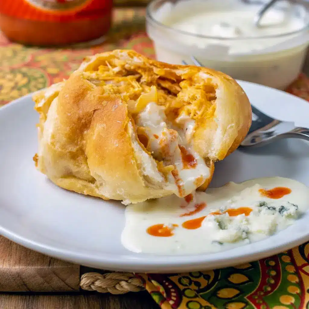 Easy Game Day Dinner Ideas: golden Buffalo Chicken Bombs on a platter, brushed with butter and served with blue cheese dressing and celery sticks.