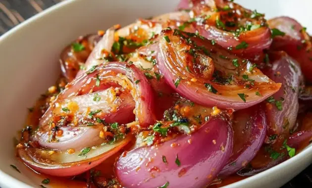 Jar of glossy Hot Honey Pickled red onion rings, bright pink and ready to top tacos or salads — a handy Quick Pickled Onions condiment.