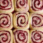 Freshly baked Sourdough Raspberry Lemon Rolls Recipe arranged in a baking dish, showcasing golden swirls of Raspberry Sourdough filled with jammy fruit, inspired by classic Sourdough Raspberry Roll Recipe techniques and vibrant Lemon Raspberry Sourdough flavors, perfect for fans of homemade Sourdough Raspberry Rolls and creative Sourdough Raspberry Recipes.