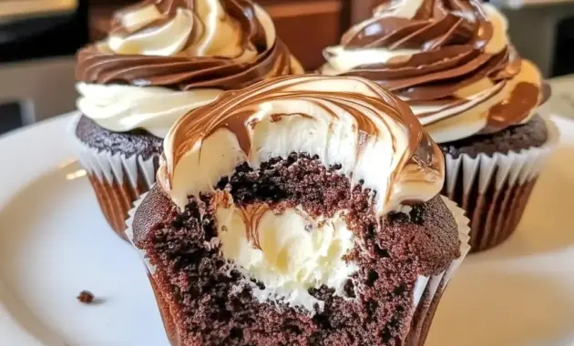 Close-up of Chocolate Coffee Cream Cupcakes showing a pillowy coffee-cream center and shiny dark chocolate ganache.