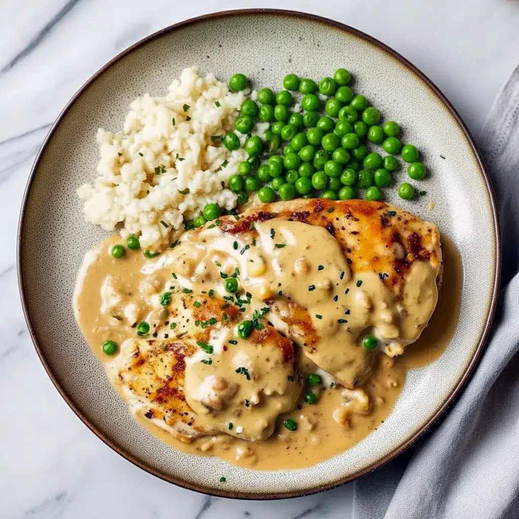 Golden-browned Boursin Cheese Chicken Bake topped with crispy panko and Parmesan, served on a plate with roasted asparagus.