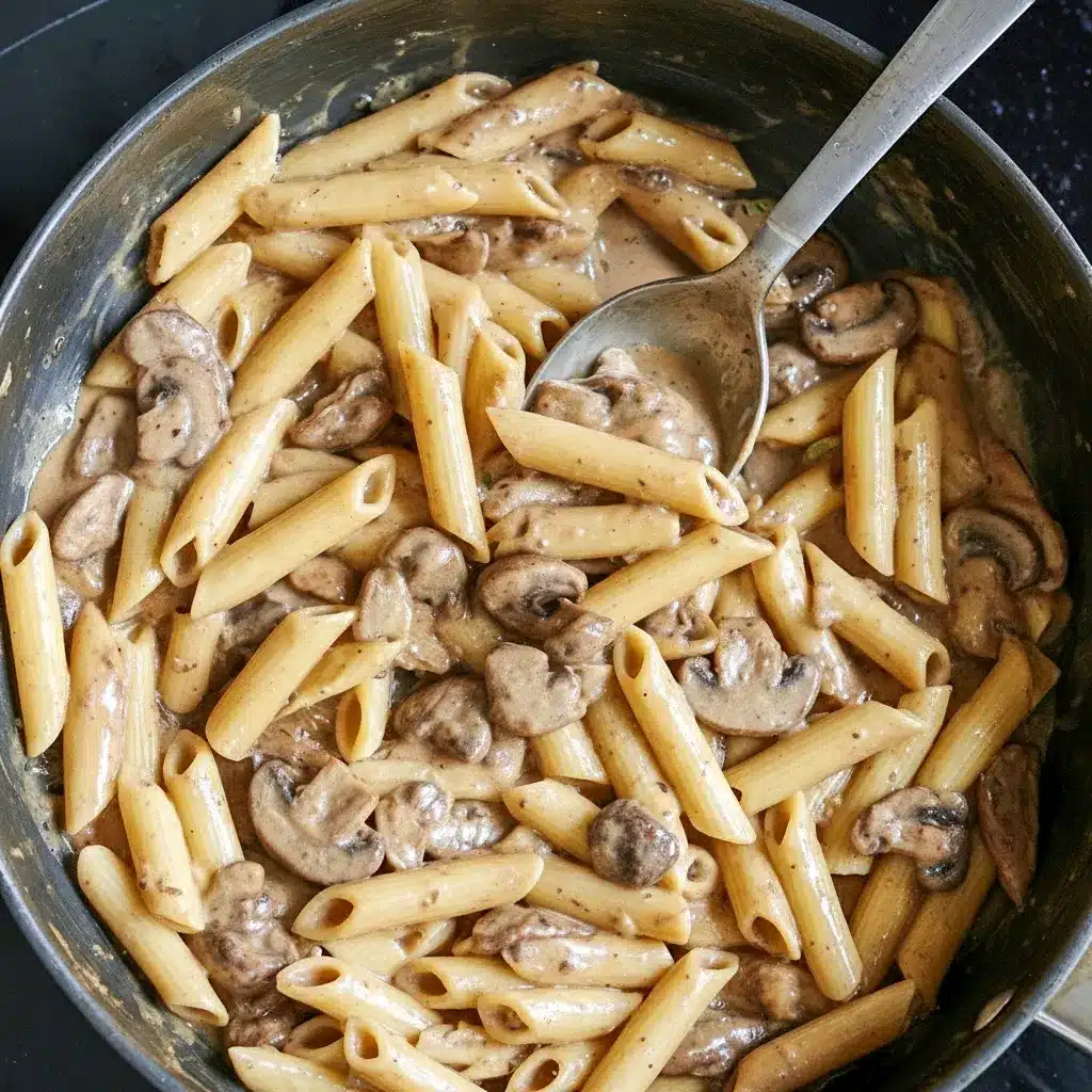 Close-up of Balsamic Mushroom Pasta coated in a glossy Balsamic Sauce For Pasta, finished with grated Parmesan and fresh thyme.