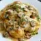 Mushroom Asiago Chicken Recipe — skillet of tender chicken in a creamy Asiago-mushroom sauce, garnished with thyme and grated cheese.