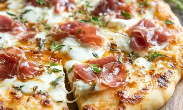 Home Pizza Ideas close-up of a white pizza with ricotta, melted mozzarella, beef prosciutto, and hot honey drizzle — a tasty example of Pizza Recipes Toppings and Fancy Pizza Toppings.