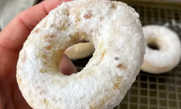 Golden, glazed Donuts stacked on a plate — close-up of a Protein Air Fryer Donut from an Easy Protein Donut Recipe guide, ready to bite into.