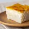 Close-up of a golden Sticky Coconut Cake square with sticky shredded coconut and a toasted crust — a classic Indonesian Dessert Recipes snack.