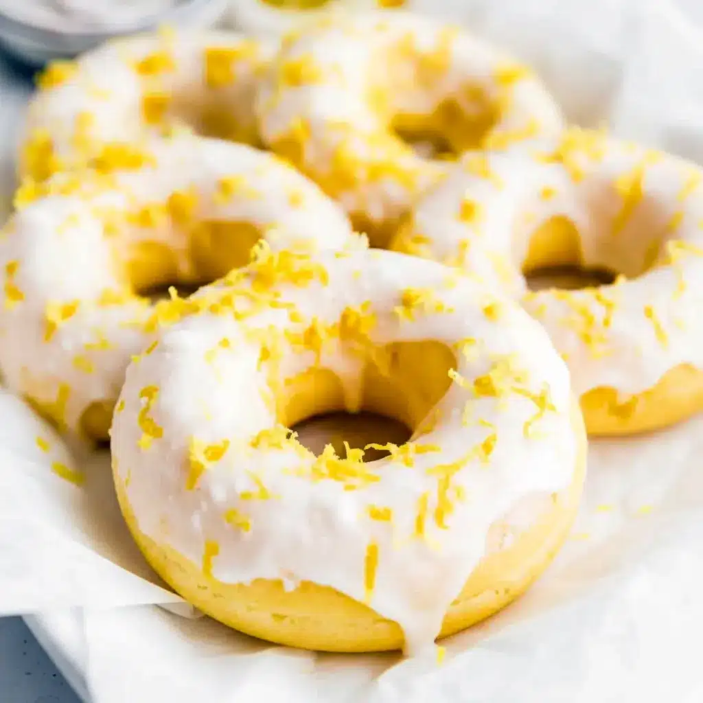 Stack of lemon-vanilla baked donuts with a glossy glaze — Easy Protein Donut Recipe styled as Glazed Protein Donuts and labeled Gluten Free Protein Donuts.