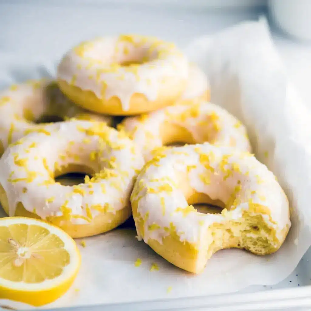 Stack of lemon-vanilla baked donuts with a glossy glaze — Easy Protein Donut Recipe styled as Glazed Protein Donuts and labeled Gluten Free Protein Donuts.