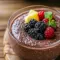 Chocolate Chia Pudding in a glass jar topped with raspberries and toasted almonds, creamy chocolate pudding texture visible.