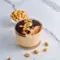 Jar of Cottage Cheese Peanut Butter Mousse drizzled with dark chocolate and chopped peanuts — a simple High Protein Desserts snack.