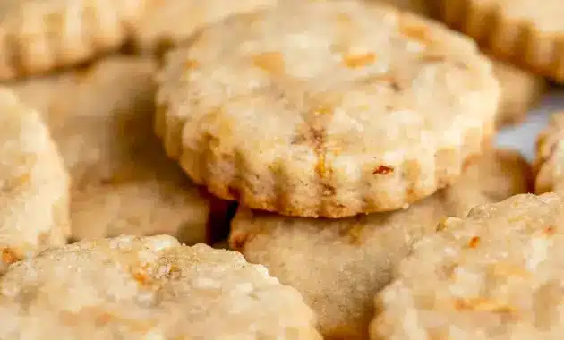 A plate of Carrot Cake Shortbread Cookies with a golden buttery texture, specks of carrot and walnut, and a light spring-inspired look for a cozy Carrot Cake Cookies pin.