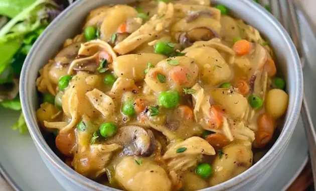 Steaming bowl of One Pot Gnocchi Chicken Pot Pie with creamy sauce, chicken, peas, carrots, and pillowy gnocchi — a cozy Soft Foods Dinner and comforting Supper Tonight idea.