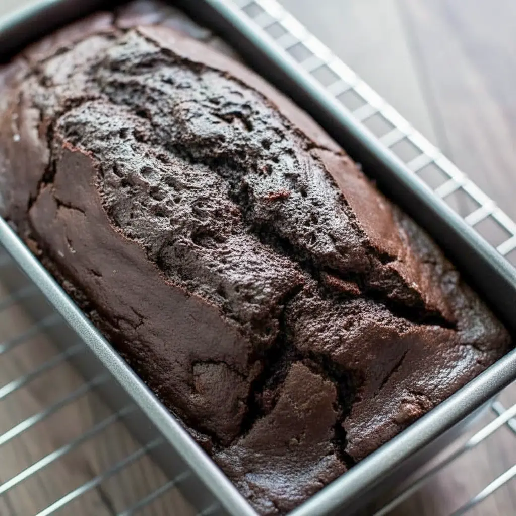 Dark Chocolate Mocha Breakfast Bread — sliced loaf with dark, tender crumb and melted chocolate chips, served on a wooden board.
