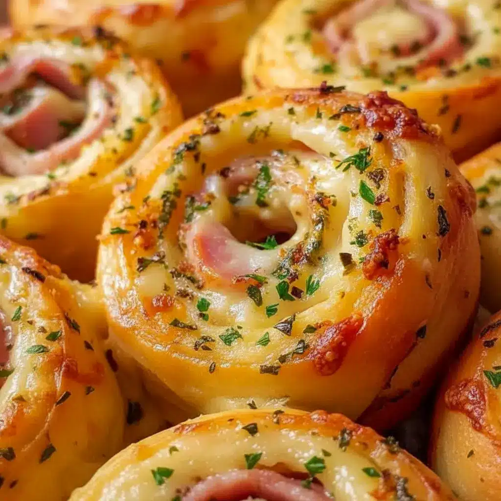Golden Ham And Cheese pinwheels on a platter, flaky and savory — tasty Ham Appetizers for Easter or party spreads.