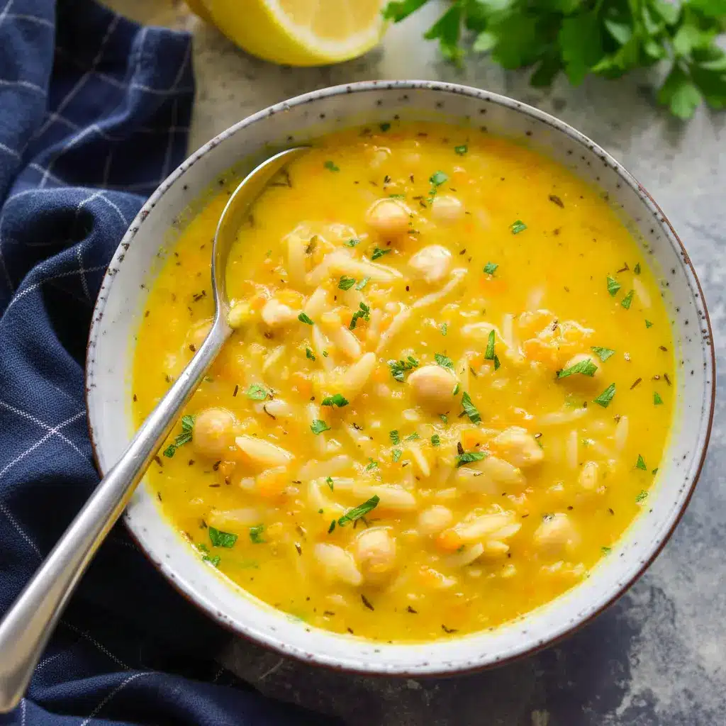 Bowl of Lemon Chickpea Orzo Soup with chickpeas, orzo, and a sprinkle of parsley in a golden, lemony broth.