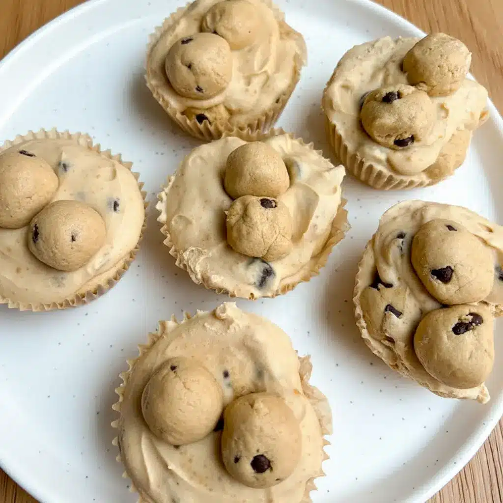 Close-up of three Cookie Dough Cups in paper liners: creamy yogurt base, little protein cookie-dough bites, and chocolate chips on top.