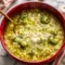 A bowl of Italian Broccoli Soup topped with parmesan cheese and olive oil, with tender broccoli, pasta, and garlic broth for a cozy homemade dinner.