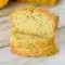 A sliced loaf of Lemon Poppy Seed Zucchini Bread with a soft golden crumb and visible poppy seeds, styled as a fresh Lemon Poppy Seed Dessert for Spring Baking Ideas.