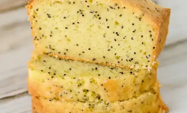 A sliced loaf of Lemon Poppy Seed Zucchini Bread with a soft golden crumb and visible poppy seeds, styled as a fresh Lemon Poppy Seed Dessert for Spring Baking Ideas.