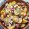 A bowl of Potato Feta Salad with tender potatoes, crumbled feta, Kalamata olives, red onion, and dill, styled as one of the Best Cold Side Dishes for a fresh and colorful meal.
