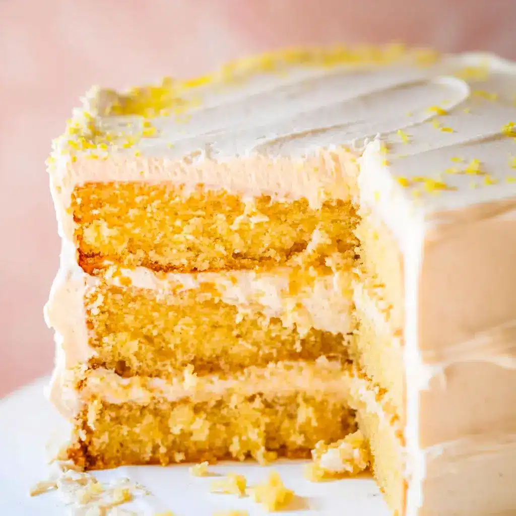 Close-up of a slice of Cornbread Cake layered with whipped honey buttercream, golden cornmeal crumb, and a honey drizzle — a rustic Cornbread Layer Cake that reads like a Cake Like Cornbread Recipe.