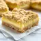 Lemon Crumb Bars with a buttery crumb topping, creamy lemon filling, and a light powdered sugar finish on a serving tray.