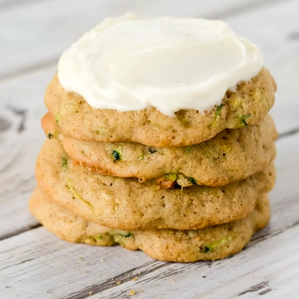 A plate of Zucchini Cookies topped with creamy frosting, styled as a soft homemade dessert inspired by Zucchini Cookies With Cream Cheese Frosting and Zucchini Recipes Cookies.