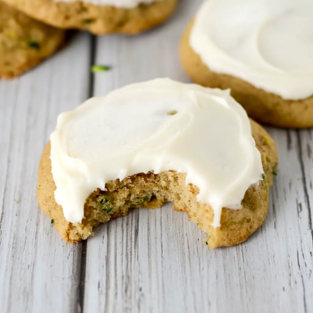 A plate of Zucchini Cookies topped with creamy frosting, styled as a soft homemade dessert inspired by Zucchini Cookies With Cream Cheese Frosting and Zucchini Recipes Cookies.